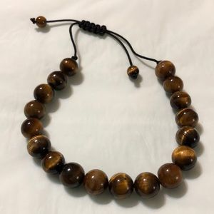 Men’s brown beaded bracelet with black draw string